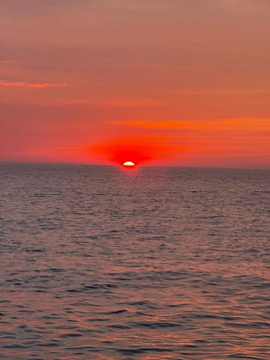 Deep red sun setting over the Arabian Sea