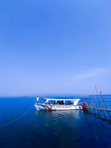 The boat on deep blue water in the evening